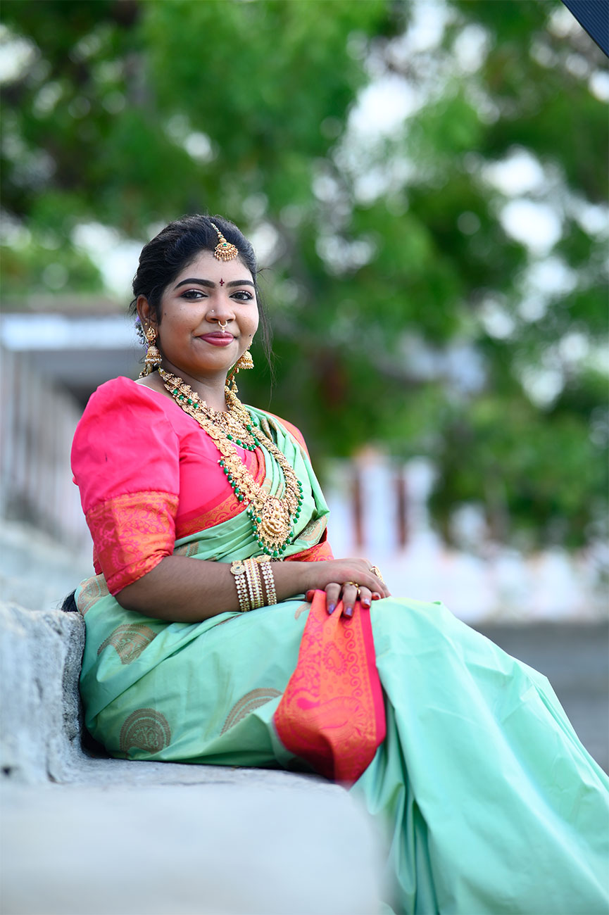 Bridal portrait seated in green saree